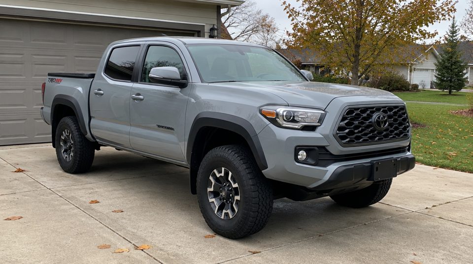 Sample listing photo: a gray pickup truck in a driveway (AI-generated)